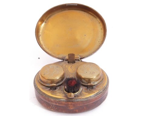 Victorian leather encased and metal framed travelling double inkwell, the hinged lid opening to reveal two hinged lidded (sea