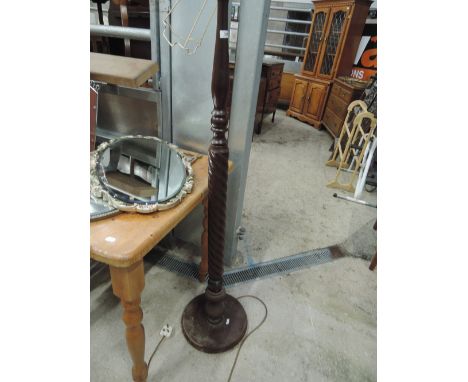 A mahogany standard lamp having wrythen column
