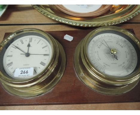 A modern mounted ship's style clock and barometer
