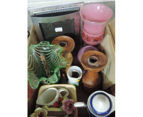 A box containing art glass, plated photo frames, treen candlesticks etc