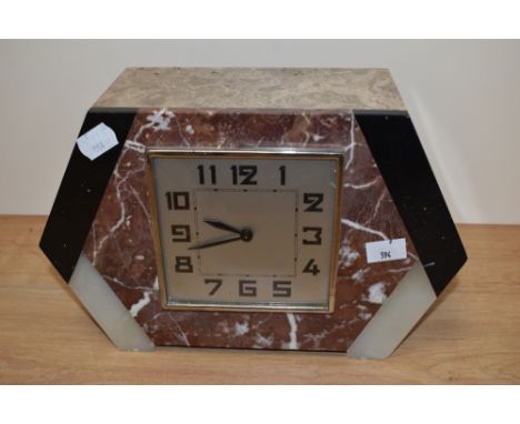 An Art Deco mantle clock oconstructed with varying shades of marble.
