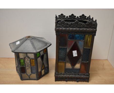 Two antique stained glass lamp shades, one of hexagonal form and the other rectangular.