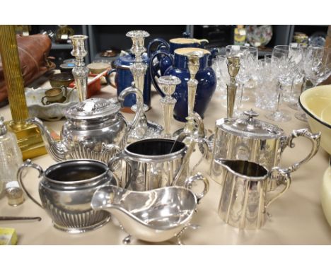 A selection of plated ware, including candlesticks, etched teapot, jug and sugar basin, gravy boat etc.