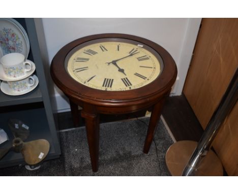 A stained wood coffee table, having working clock face under glass with quartz movement. approx 22' wide and 21.5' high.