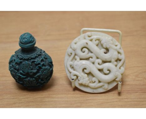 A Chinese carved white jade plaque, depicting two intertwined dragons and a carved Chinese turquoise snuff bottle.Note - The 