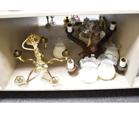 A vintage brass ceiling light, having five arms and a carved oak ceiling light with four arms, also included are four glass s