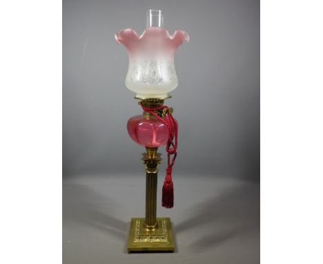 VICTORIAN OIL LAMP, brass Corinthian column base with Cranberry glass font and pink tinted frill shade, 74cms overall H inclu