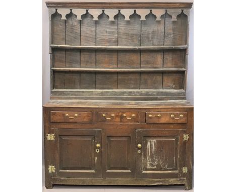 CIRCA 1760 WELSH OAK DRESSER having a three shelf stepped rack with thick backboards and later decorative top detail over a t