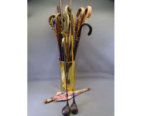 BRASS STICK STAND with assorted stick and umbrella contents and two old golf clubs