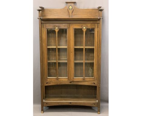 ARTS &amp; CRAFTS PERIOD OAK BOOKCASE having a galleried top with central inlay repeated to the twin door, central bars, inte