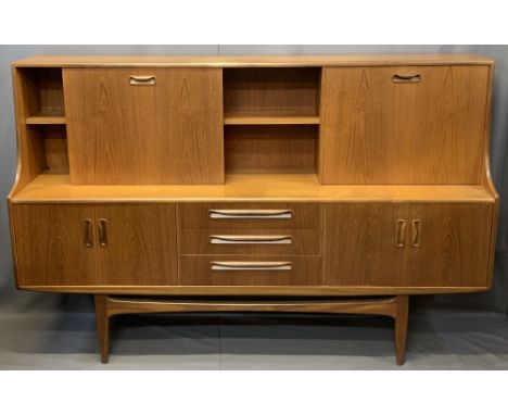 MID-CENTURY LONG TEAK SIDEBOARD with drop down top cupboards and central shelf over three central drawers and flanking twin c