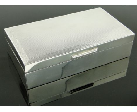 Engine turned silver cigarette box, 
length 15.5cm.