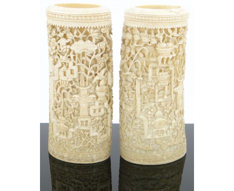 A pair of Chinese relief carved and pierced ivory tusk sections,
decorated with vases of flowers and tropical birds, height 9