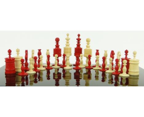 A 19th century Chinese red and white stained bone chess set,
king height 4", together with a double set of bone dominoes.