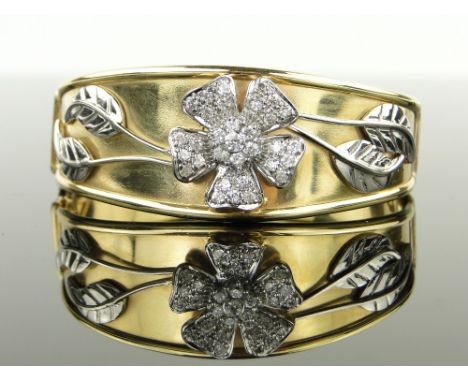 A 14ct gold hinged bangle,
with central diamond set flower head mount, width 23mm, 32g.