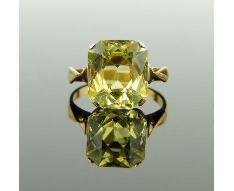 A synthetic yellow sapphire set ring,
gold settings with indistinct marks, stone height 12mm, size L.