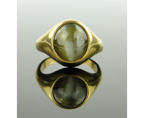 An unmarked gold tiger's eye set ring,
setting height 14mm, size P.