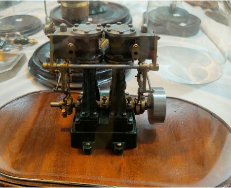 A scratch built model steam powered engine under glass dome in green 