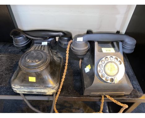 A vintage black Bakelite cased rotary telephone and another similar 