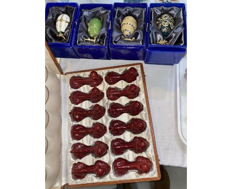 8 originally boxed copies of Faberge eggs; a boxed set of 12 ceramic dog knife rests 