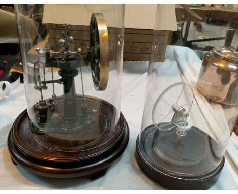 A steam powered engine under glass dome; another under dome..&nbsp; Condition report:-&nbsp;23.5cm height to top of the wheel