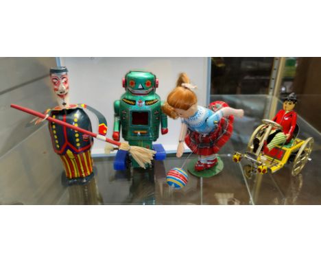 A Vintage Japanese tin plate clockwork robot and three other tin plate toys 