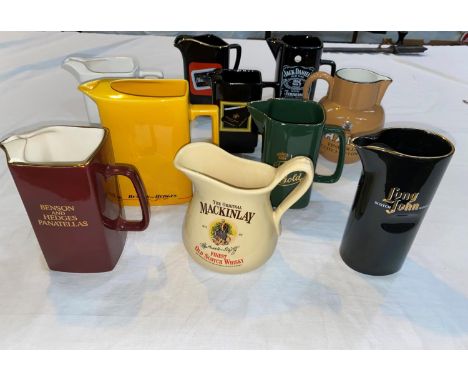 A selection of ceramic pub advertising water jugs 