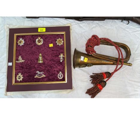 9 framed military cap badges; a Royal Welsh Fusilier's bugle 