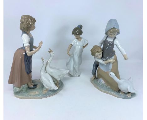 A Lladro group of young boy and girl with goose; a Nao figure of girl with two geese and a single Nao girl 