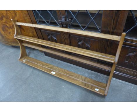 An Ercol elm wall rack 