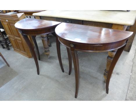A pair of small Regency style mahogany demi lune console tables 