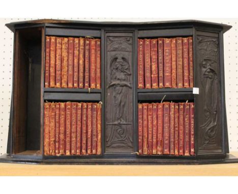 The Temple Shakespeare 40 volume set in original leather, housed in a purpose built ebonised shelf unit with carved panels a/