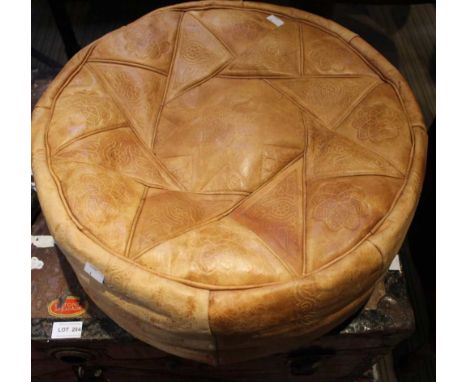 A vintage leather circular pouffe