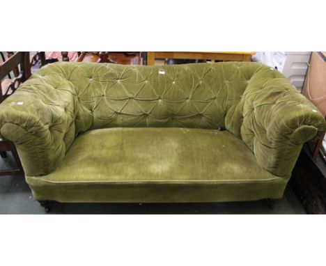 A probable early 20th century green upholstered Chesterfield two seater sofa