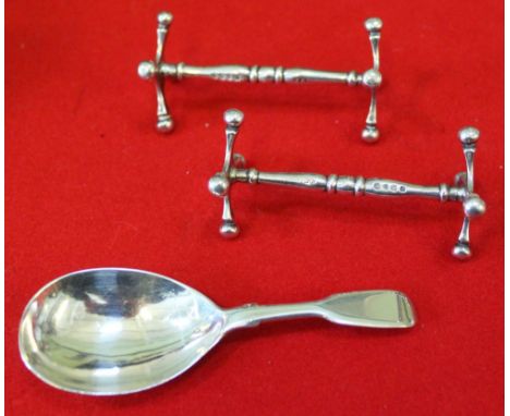 A pair of Victorian silver knife rests and a Victorian silver caddy spoon, combined weight 72g