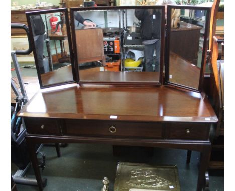 A vintage Stagg dressing table with three inline drawers and triple mirror above