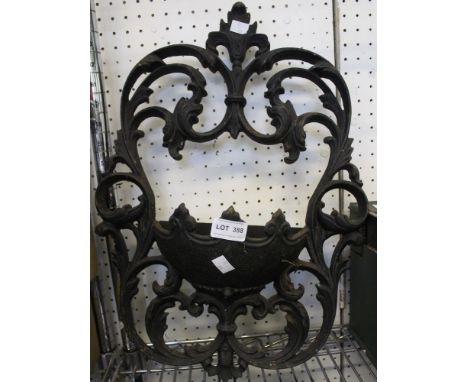 A heavy metal cast wall hanging garden planter