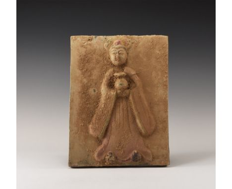 20th century AD. A rectangular ceramic plaque with high-relief image of a standing robed figure, with keying to the reverse. 