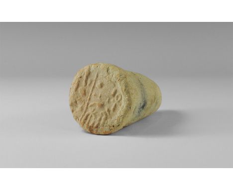 . An undated archaistic ceramic cone with flattened end impressed with two registers of hieroglyphs, in New kingdom, 1550-107