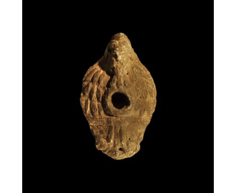 . An undated archaistic grey ceramic D-section lamp with handle formed as the head of a satyr, raised filler-hole, foliage de