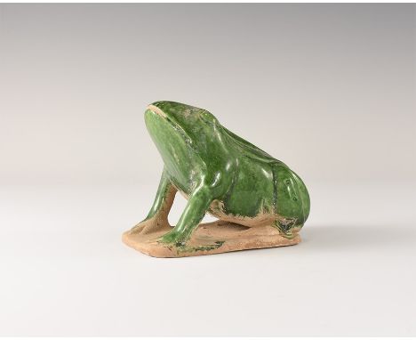 . An undated archaistic green-glazed ceramic statuette of a frog on a rectangular base, hollow to the underside. Acquired on 