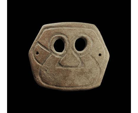 4th-3rd century BC. A trapezoidal ceramic mask with two eye-holes and incised stylised facial details; pierced for attachment