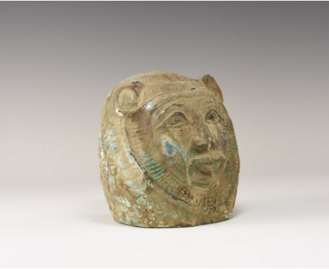 20th century AD. A blue glazed composition mask with scale headdress and feline ears in three-quarter view; hollow to the rev