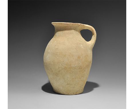 1st millennium BC. A bulbous Iron Age ceramic jar with flared rim and strap handle to the reverse. Ex Rihani family collectio