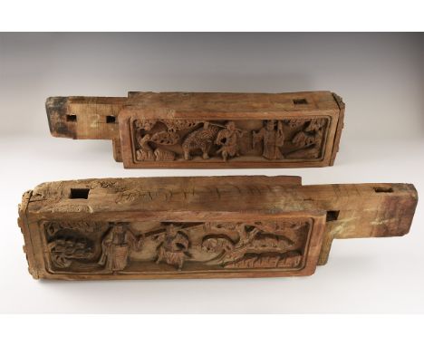 19th century AD. A matched pair of carved walnut(?) corbels with high-relief scene to one long face, scrolls to the reverse; 