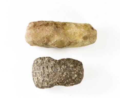 Neolithic Period, 5th-3rd millennium BC. A pair of stone tools comprising: a boat-shaped granite(?) axehead with perforation;