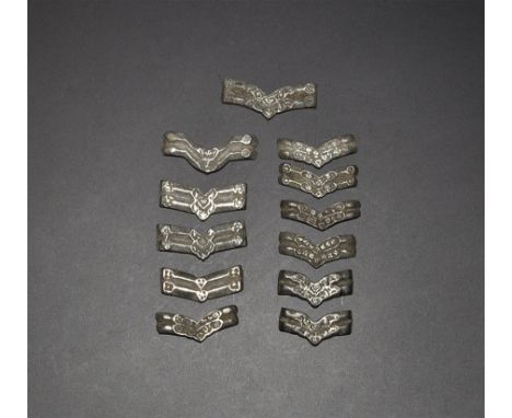 13th-15th century AD. A mixed group of copper-alloy V-shaped belt sliders or articulating scales. Property of a gentleman; ac