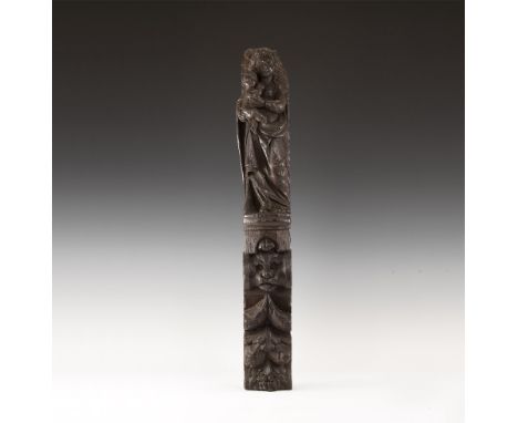 17th century. A carved wooden bracket with the figure of the Virgin Mary holding the Christ child, standing on a plinth above