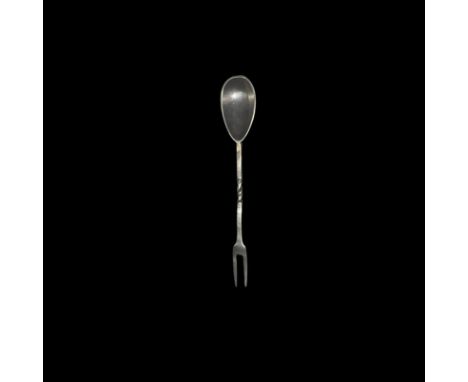 . An undated archaistic silver dining utensil combining a piriform bowl, rectangular-section shank with twisted median sectio