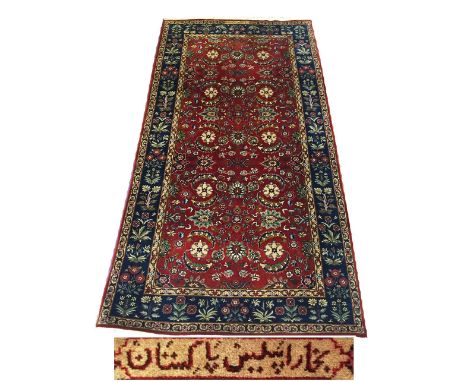 FINE SIGNED TABRIZ RUG, 198cm x 101cm, all over scrolling palmettes and vines on a ruby field within complimentary border.